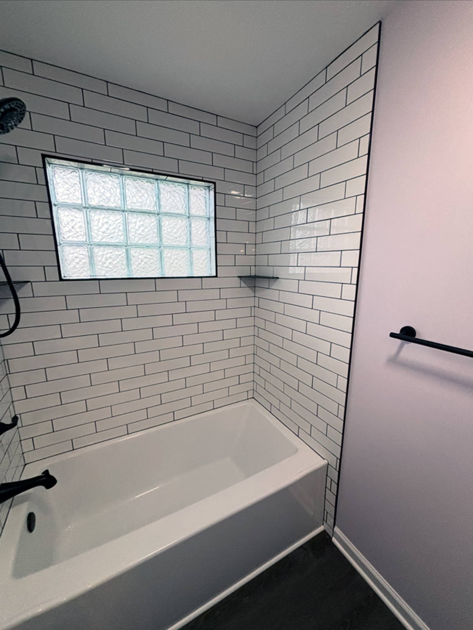 Bathroom tub area with subway tile surround and frosted window in Gahanna, OH